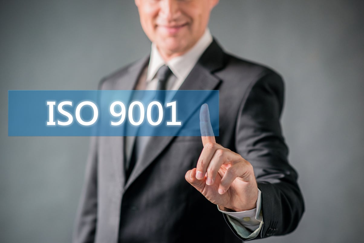 businessman pointing at virtual  ISO 9001 sign